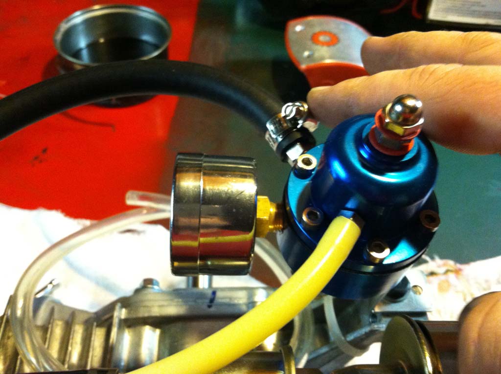 Image of surgical tubing coming from the ambient pressure port of the fuel pressure regulator.